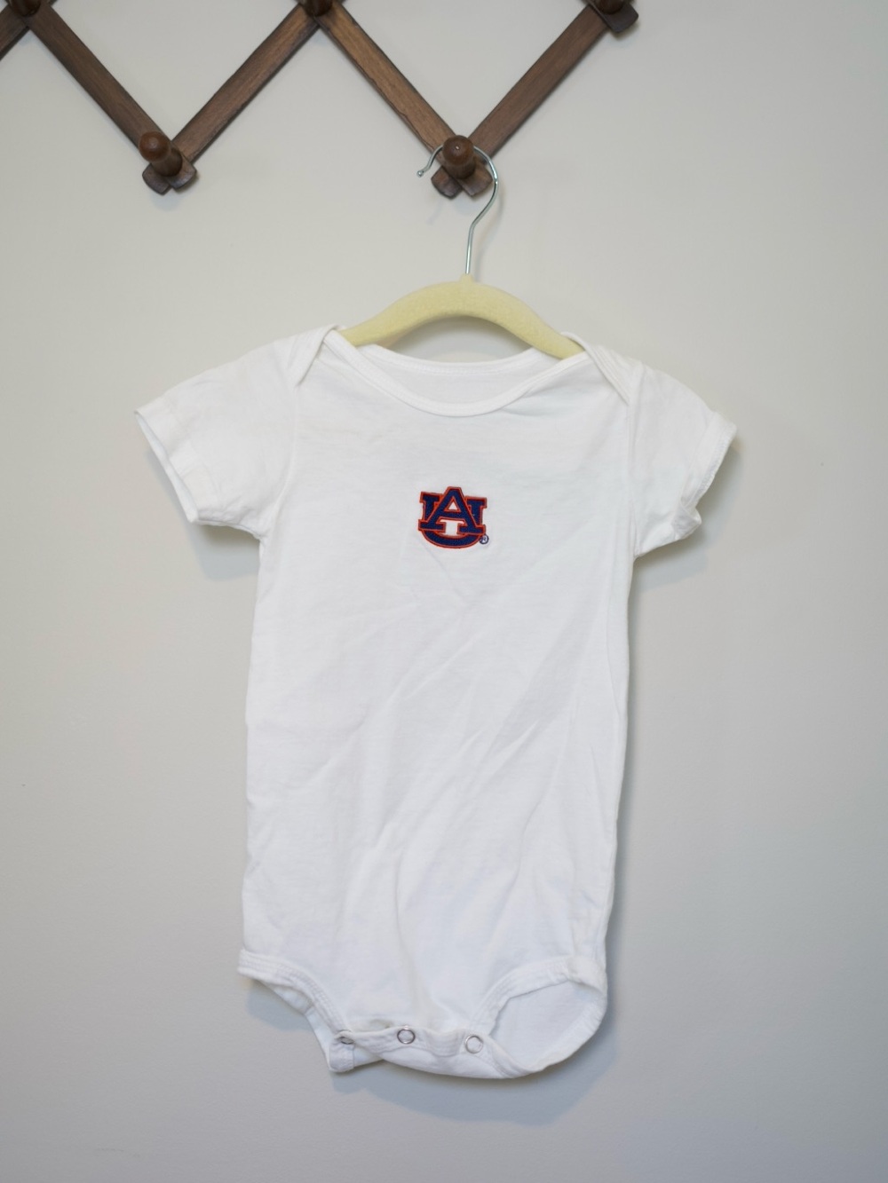 Creative Knitwear White Baby One-Piece Bodysuit with Auburn Logo